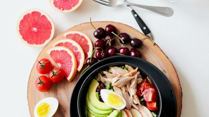 bowl of vegetable salad and sliced fruits